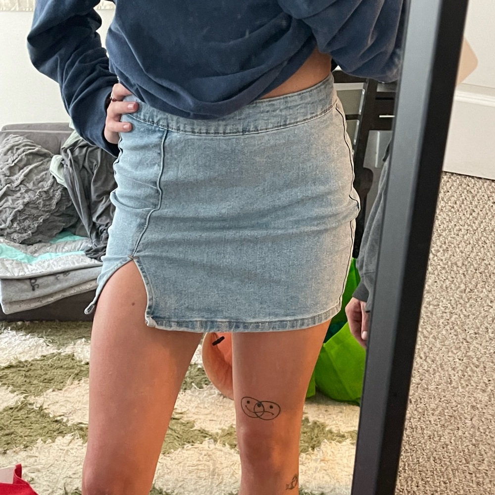 Light wash mini jean skirt with small slit